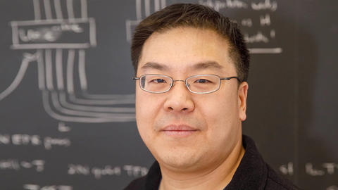 Prof. Norman Yao headshot in front of blackboard