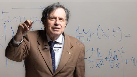 Prof. Georgio Parisi writing on a glass wall