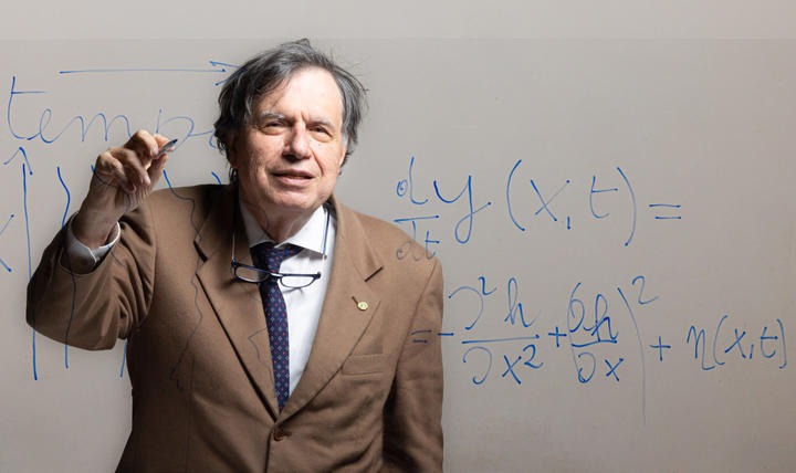 Prof. Georgio Parisi writing on a glass wall
